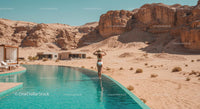 Woman Enjoying Infinity Pool by Desert Mountains