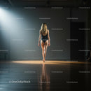 Model Walking Confidently in Spotlight on Runway