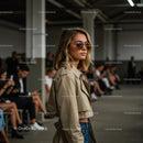 Stylish Woman in Beige Trench Coat at Fashion Show