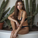 Woman in Black Bikini Sitting by Cactus Plants