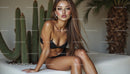 Stylish Woman in Black Bikini Amidst Desert Plants