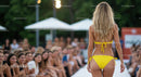 Model in Yellow Bikini Walking Down Fashion Show Runway
