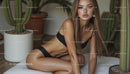 Elegant Woman in Black Bikini Posed Amidst Indoor Cacti
