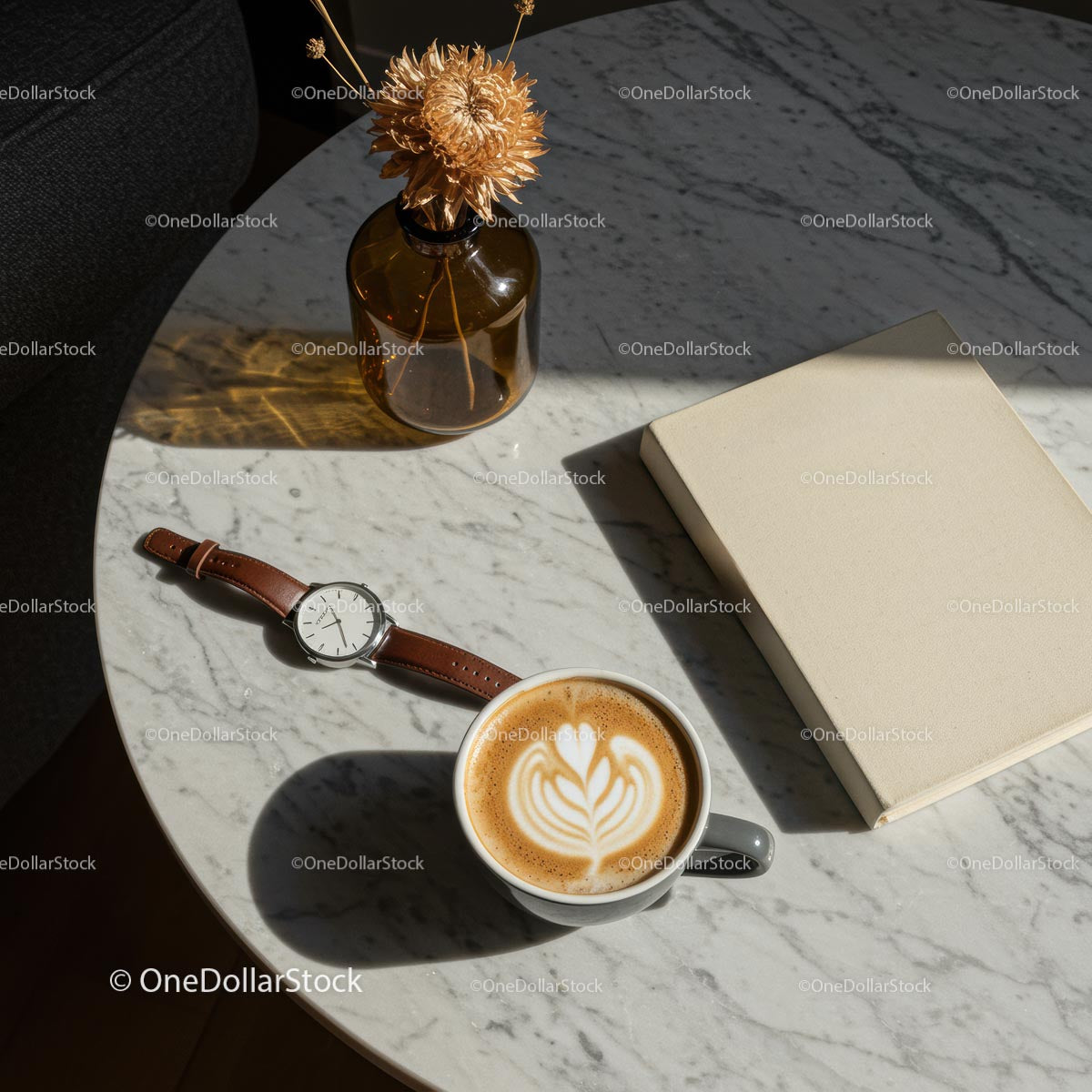 Elegant Marble Table with Coffee, Watch, and Book