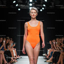 Confident Model in Orange Swimsuit on the Runway