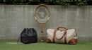Stylish Tennis Gear with Bags against Concrete Wall