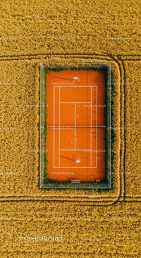 Solitary Tennis Player on Green Court with Lush Surroundings