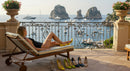 Woman Relaxing on Terrace Overlooking Coastal Scenery
