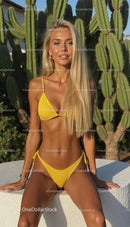 Blonde Woman in Yellow Bikini with Cactus Backdrop