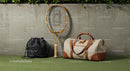 Tennis Racket and Bags Against Concrete Wall Outdoors