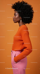 Elegant Woman in Orange Sweater and Pink Pants