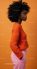 Stylish Woman in Orange Sweater and Pink Pants Side Profile