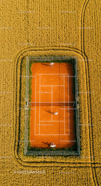 Solitary Tennis Player on Green Court with Lush Surroundings