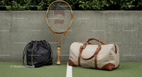 Vintage Tennis Racket and Stylish Bags on Green Court