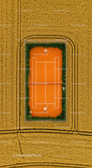 Solitary Tennis Player on Green Court with Lush Surroundings