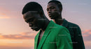 Two Friends Reflecting at Sunset in Vibrant Attire