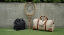 Tennis Racket and Elegant Travel Bags on Green Grass