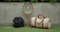 Tennis Racket and Elegant Travel Bags on Green Grass