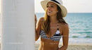 Smiling Woman in Sun Hat Enjoying Sunny Beach