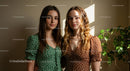 Stylish Women in Polka Dot Dresses under Sunlit Interior