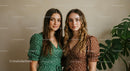 Two Women in Polka Dot Dresses with Greenery
