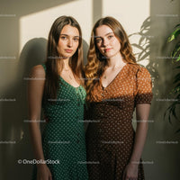 Two Women in Polka Dot Dresses Standing in Sunlight