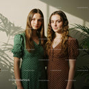 Two Women in Polka Dot Dresses with Plant Shadows