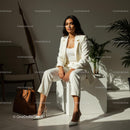 Confident Businesswoman in White Suit in Sunlit Office
