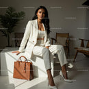 Elegant Woman in White Business Suit with Brown Leather Bag
