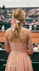 Elegant Spectator in Pink Dress at Tennis Match