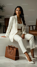 Confident Businesswoman in White Suit with Leather Bag