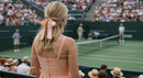Elegant Spectator at an Exciting Tennis Match