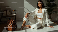 Elegant Woman in White Suit with Brown Leather Bag