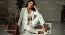 Elegant Woman in Chic White Suit Relaxing Indoors