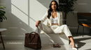 Confident Woman in White Suit with Brown Handbag