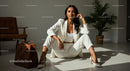 Confident Woman in White Suit in Modern Interior