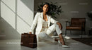 Elegant Woman in White Suit with Brown Leather Bag