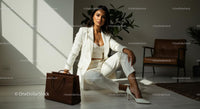 Elegant Woman in White Suit with Brown Leather Bag