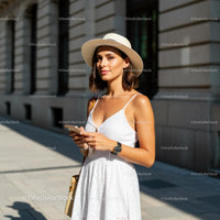 Woman in White Summer Dress with Sun Hat and Smartphone