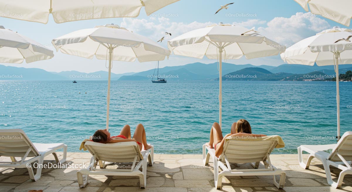 Sunbathers Relaxing by the Tranquil Mediterranean Sea