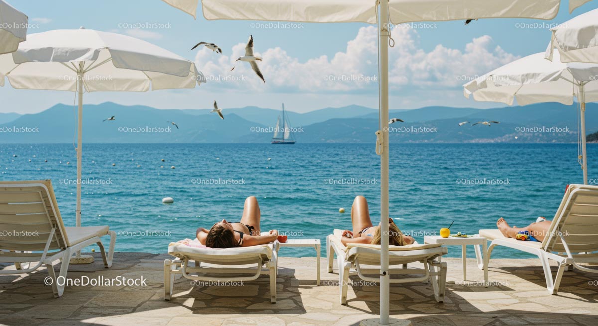Sunbathers Relax Under Parasols by the Blue Sea