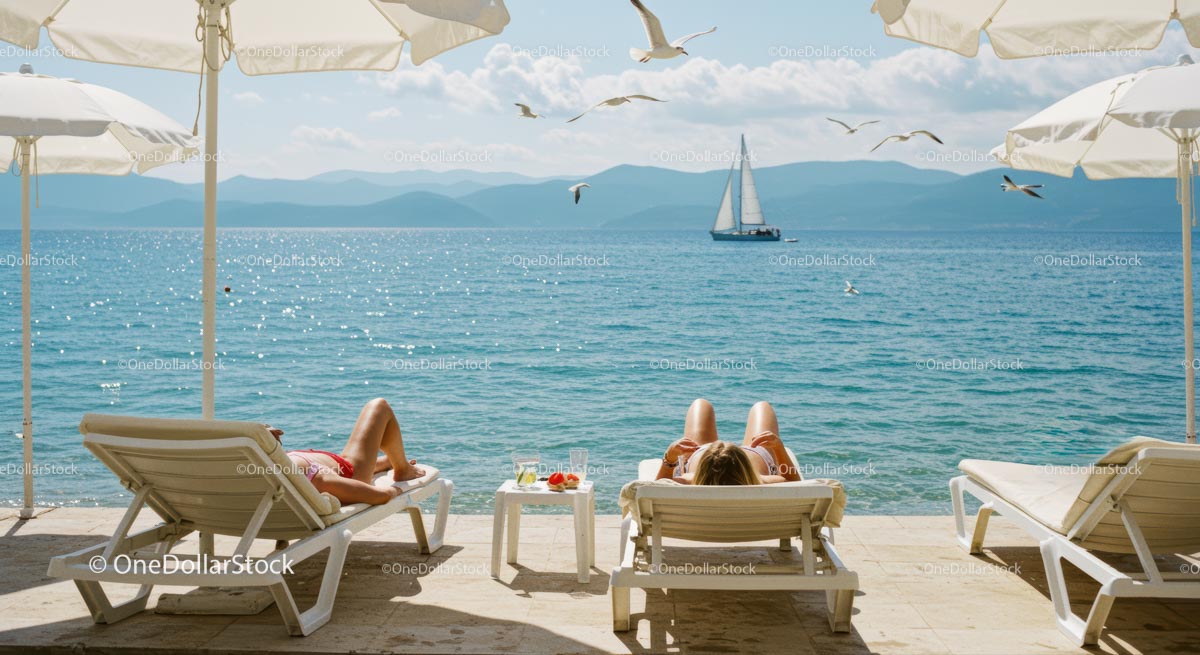 Sunbathing by the Seaside with Sailing Boat in View