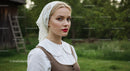 Traditional Woman in Vintage Attire in Lush Countryside