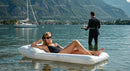 Woman Relaxing on Inflatable Lounge in Scenic Lake Setting