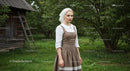 Woman in Traditional Dress in Lush Countryside Setting