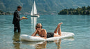 Woman Relaxing on Inflatable Mattress in Mountain Lake