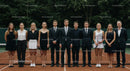 Formal Tennis Team Standing on Clay Court
