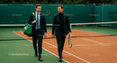 Businessmen Discussing Strategy on Tennis Court