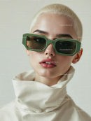 Elegant Woman in Green Sunglasses and High-Collar Outfit