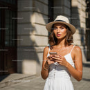 Stylish Woman with Smartphone in City Sunlight